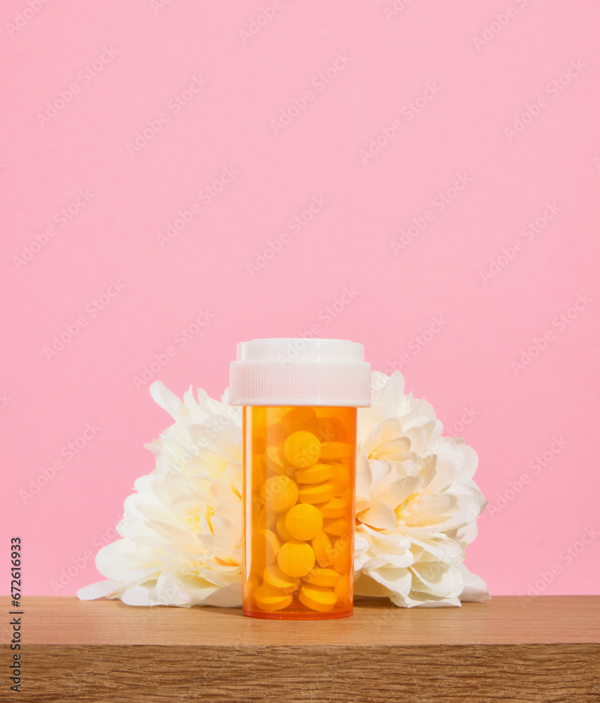 Orange medical jar with white pills for wellness. Vitamins and supplements. Orange medical jar with white pills for wellness. Vitamins and supplements.