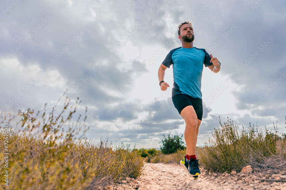 Middle-aged man running in nature with copy space Middle-aged man running in nature with copy space