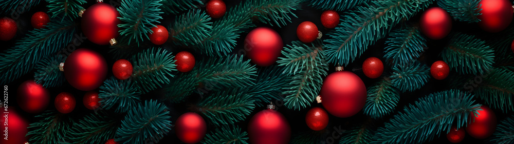 Fir branches and red balls and baubles green needle abstract background Christmas texture. Horizontal composition, banner.