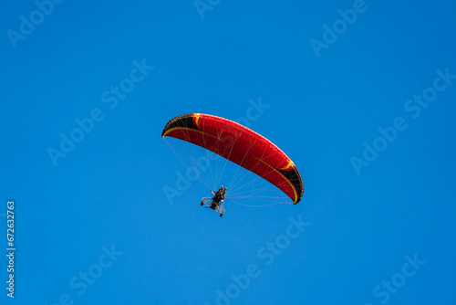 Wallpaper Mural Flying with paramotor in the blue sky - Man riding paramotor in the blue sky background Torontodigital.ca