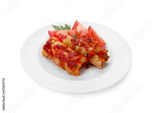 Plate of delicious stuffed cabbage rolls and tomatoes isolated on white