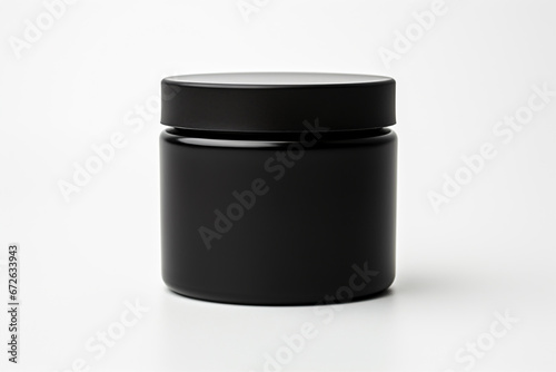 a black jar with a black lid on a white surface