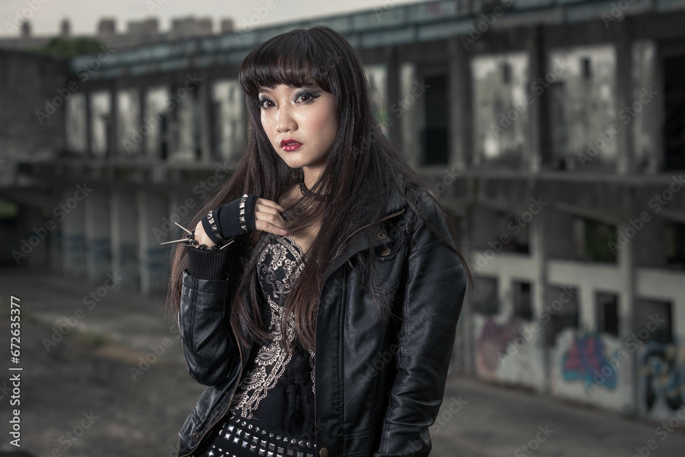 Asian woman in emo goth clothes at an abandoned building Asian woman in emo goth clothes at an abandoned building