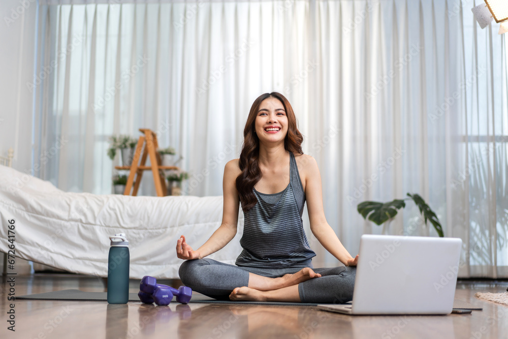 Portrait of sport slim fit strength asian woman training in sportswear sitting relax and practicing yoga, fitness, exercise, wellness, workout, sport at home.Diet concept.Fitness and healthy lifestyle Portrait of sport slim fit strength asian woman training in sportswear sitting relax and practicing yoga, fitness, exercise, wellness, workout, sport at home.Diet concept.Fitness and healthy lifestyle