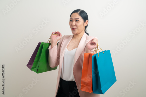 Asian woman holding shopping bag on hand
