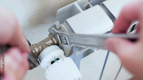 Man installing radiator valve close up photo