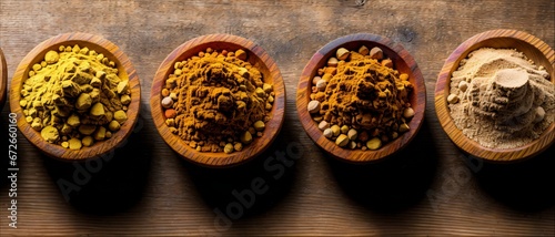 Oriental spices in wooden bowls on the table. Wooden table made of boards.