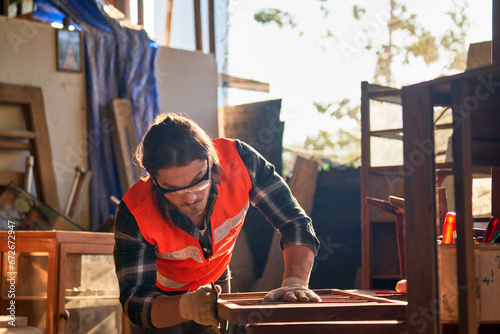 Capenter or craftman working in wood studio for craft ferniture.. photo