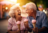 a senior couple laughing while sharing ice cream cone