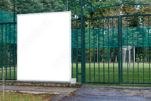 Fototapeta Naklejka Na Ścianę i Meble -  Large square billboard on green soccer field fence. Mock-up.
