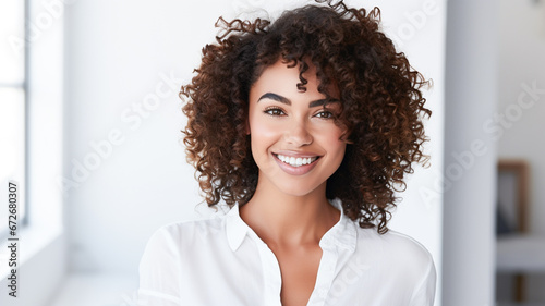 Beautiful young smiling afro american woman with curly hair portrait.