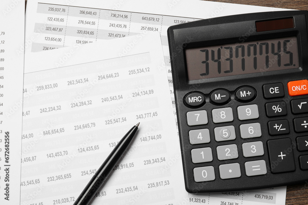 Calculator, pen and documents with data on table, flat lay Calculator, pen and documents with data on table, flat lay