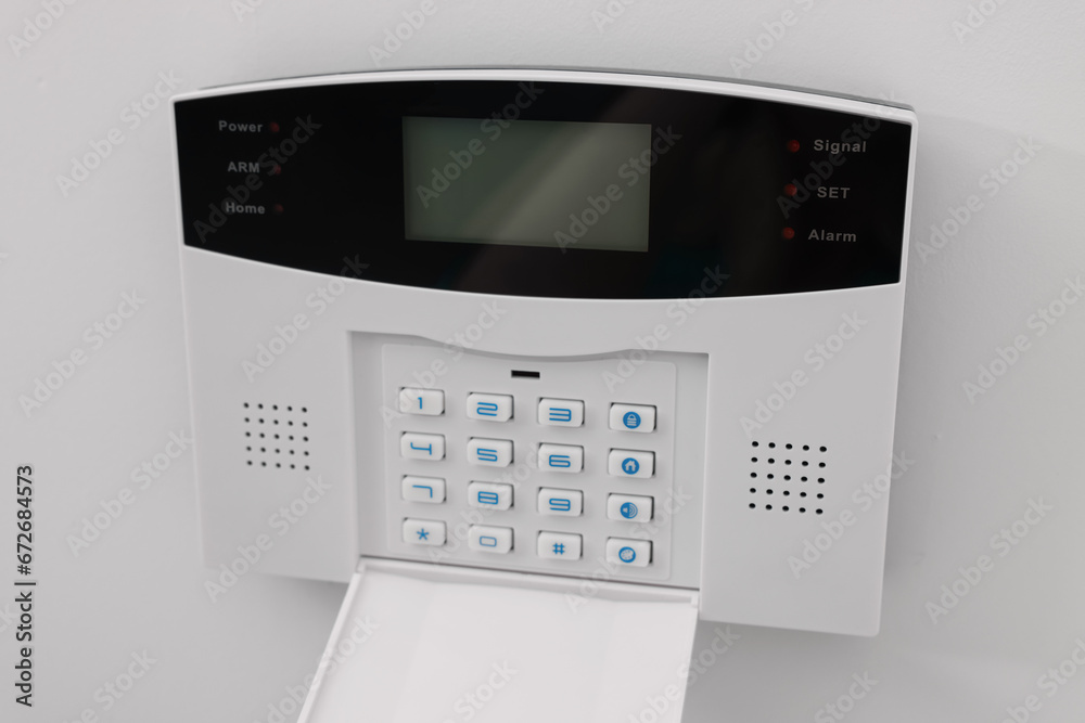 Home security alarm system on white wall indoors Home security alarm system on white wall indoors