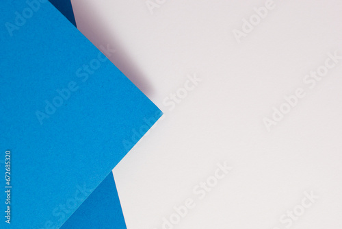 Geometric blue and white colored paper background