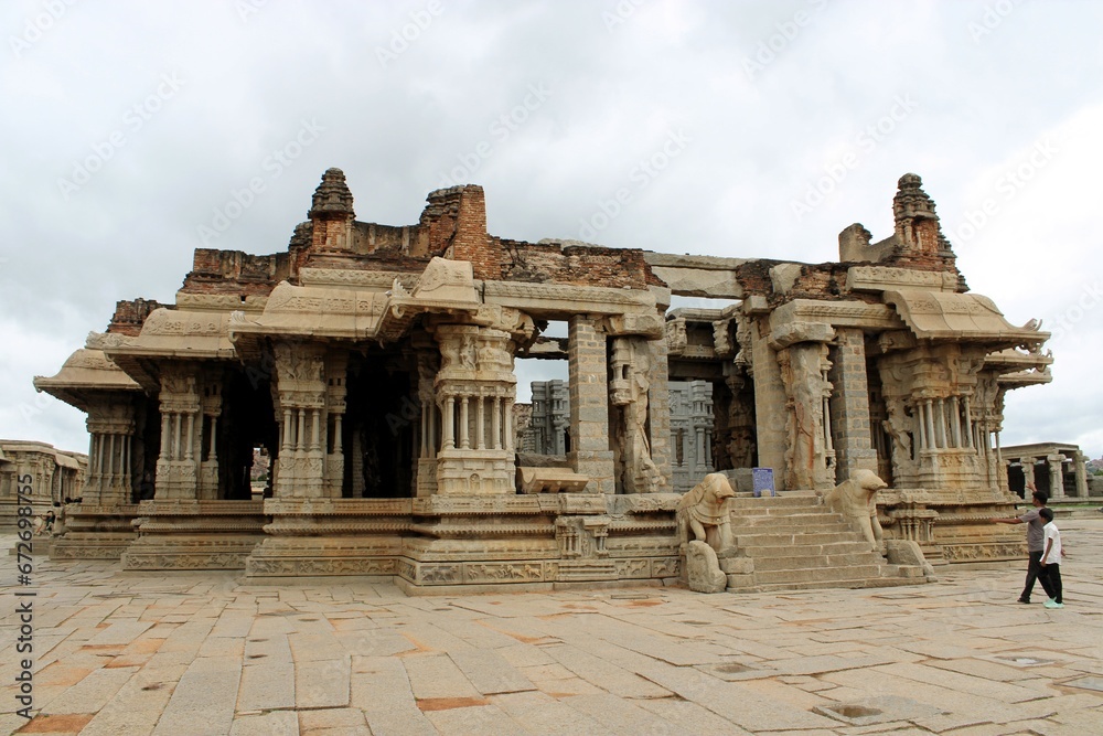 Hampi, Karnataka India - July 24 2023: Stone chariot at temple of Vijaya Vittala complex in desert valley of Hampi