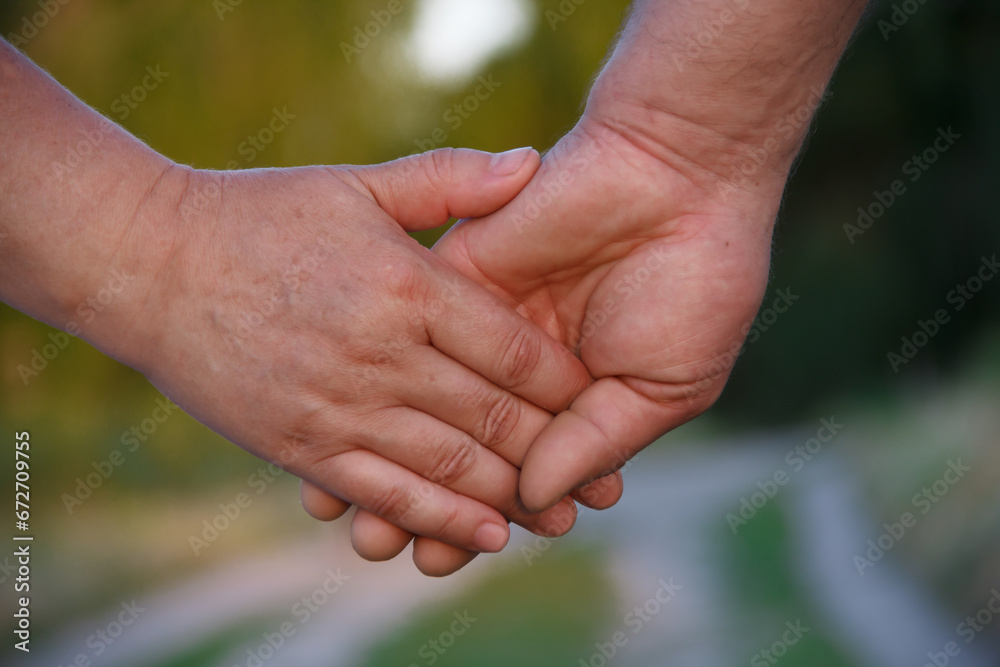 hands of elderly people who hold each other's palms. selective focus. High quality photo hands of elderly people who hold each other's palms. selective focus. High quality photo