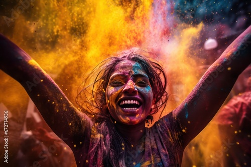 young woman face closeup at holi festival in India covered with colorful paint powder photo