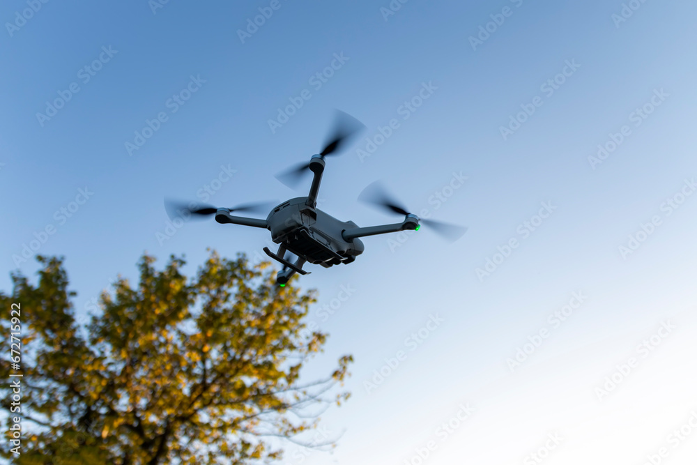 Quadcopter in flight. Unmanned aerial vehicle. Quadcopter on a blue sky background. Remote video shooting from a height. Photos and videos from above. Hobby. Intelligence equipment Quadcopter in flight. Unmanned aerial vehicle. Quadcopter on a blue sky background. Remote video shooting from a height. Photos and videos from above. Hobby. Intelligence equipment