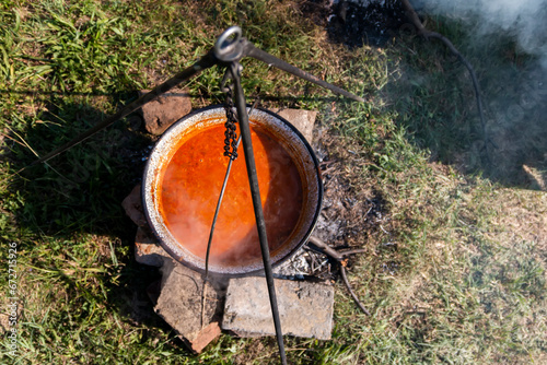 Camping kitchenware - pot on the fire at an outdoor campsit © Jelena