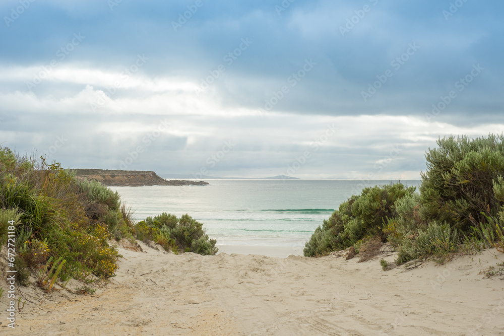 Sandy walkway down to beach on a cloudy day Sandy walkway down to beach on a cloudy day
