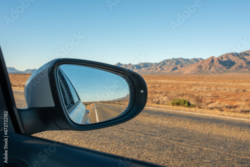 Side mirror of car showing road through Flinders Ranges, SA