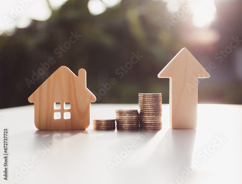 Obraz na plátně Coins money stacks, house sign symbol and up arrow concepts for success, methods, systems of raising or lowering Fed interest rates to correct inflation concepts