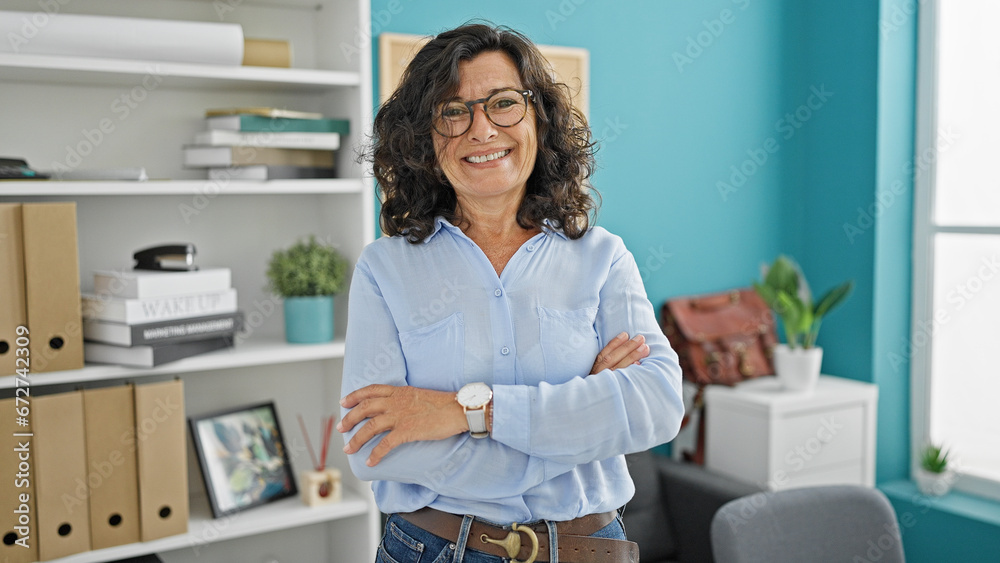 Middle age hispanic woman business worker standing with arms crossed gesture smiling at the office Middle age hispanic woman business worker standing with arms crossed gesture smiling at the office