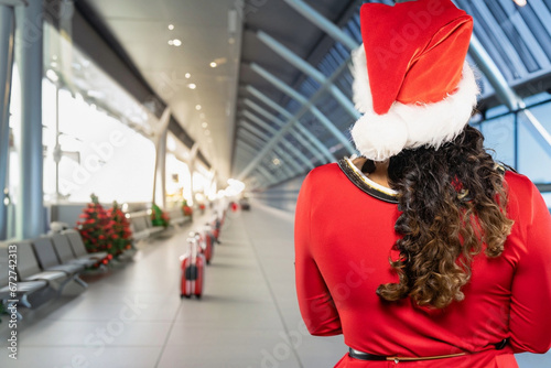 christmas concept at airport holidays with female santa claus