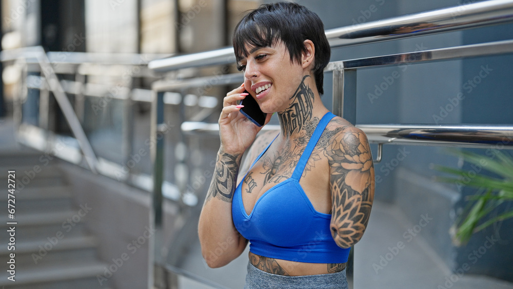Hispanic woman with amputee arm smiling confident talking on the smartphone at street Hispanic woman with amputee arm smiling confident talking on the smartphone at street
