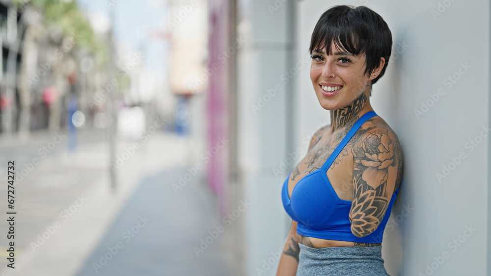 Hispanic woman with amputee arm smiling confident standing at street