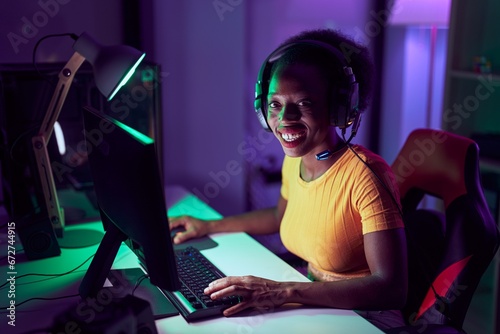 African american woman streamer using computer at gaming room