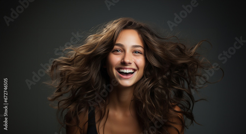 Healthy hair brunette advertisement model. Brunette girl Smiling beautiful model woman with long curly hairstyle. Care and beauty hair products Copy space