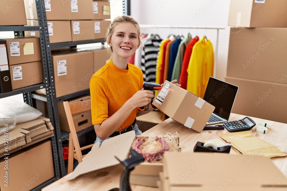 Young blonde woman ecommerce business worker scanning package at office Young blonde woman ecommerce business worker scanning package at office