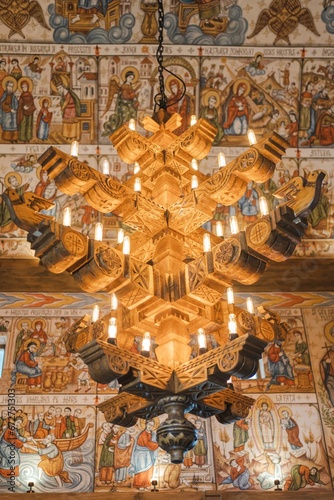 a large chandelier hanging from the ceiling in a church