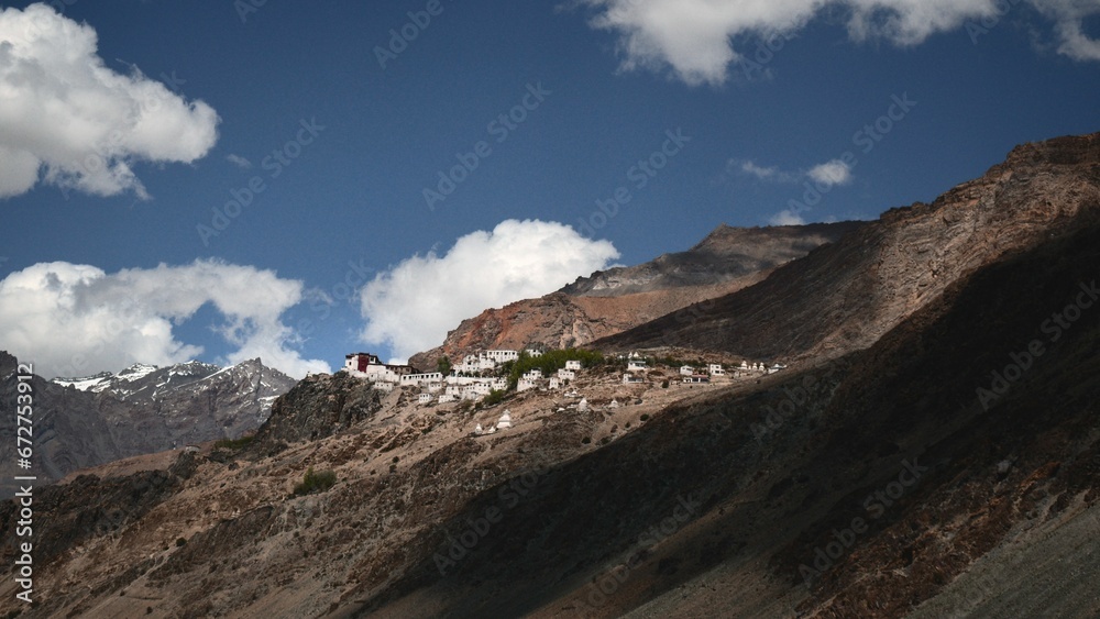 Scenic view of a mountain side, featuring several houses on the peaks