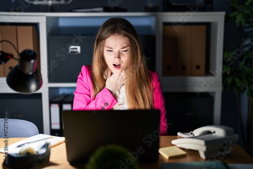 Young caucasian woman working at the office at night shouting and suffocate because painful strangle. health problem. asphyxiate and suicide concept.
