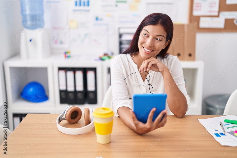 Young beautiful hispanic woman business worker using touchpad working at office Young beautiful hispanic woman business worker using touchpad working at office