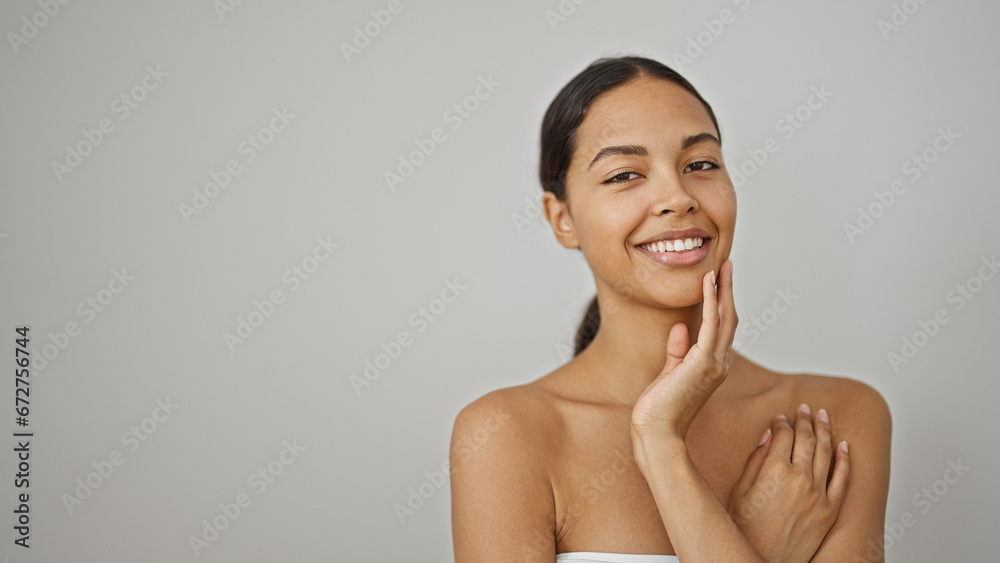 African american woman smiling confident touching face over isolated white background African american woman smiling confident touching face over isolated white background