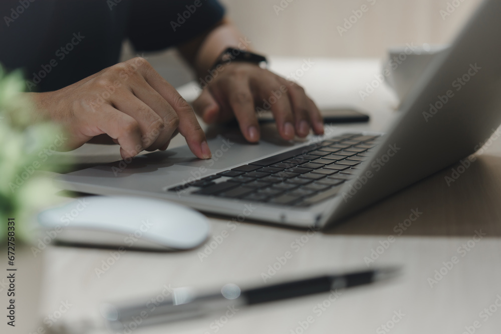 businessman typing on a laptop browsing the internet at home working digital data online businessman typing on a laptop browsing the internet at home working digital data online