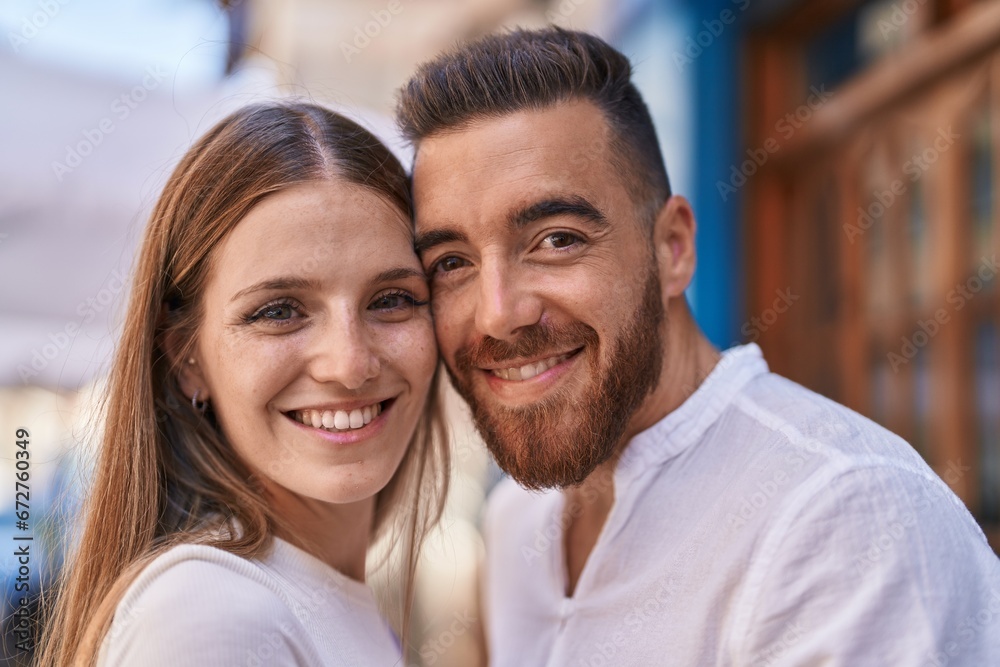 Man and woman couple smiling confident hugging each other at street Man and woman couple smiling confident hugging each other at street
