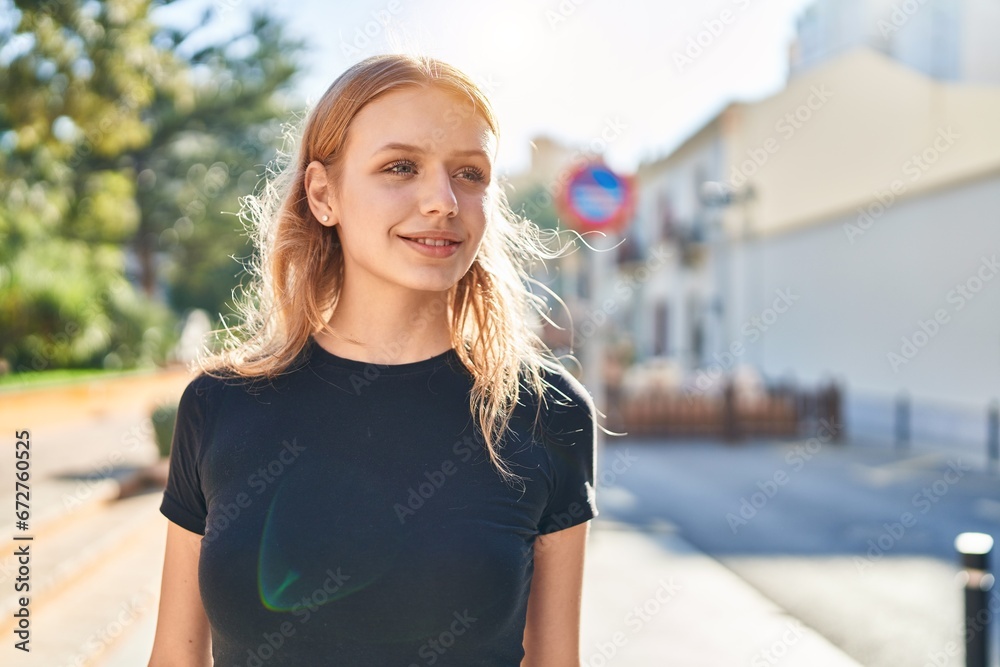 Young blonde woman smiling confident looking to the side at street Young blonde woman smiling confident looking to the side at street