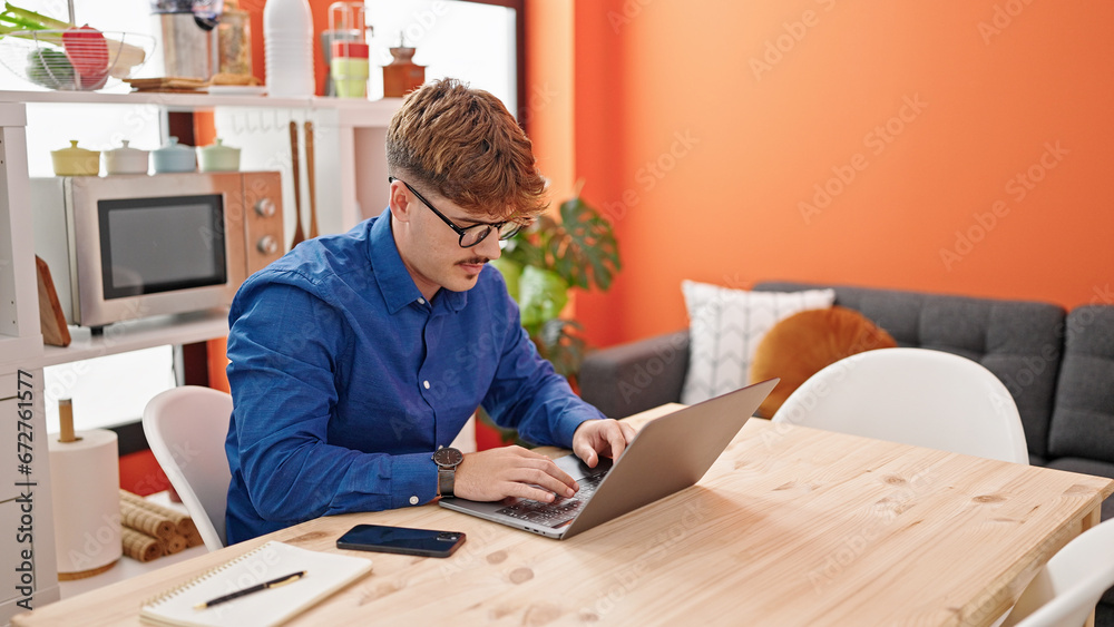 Young hispanic man using laptop sitting on table at dinning room Young hispanic man using laptop sitting on table at dinning room