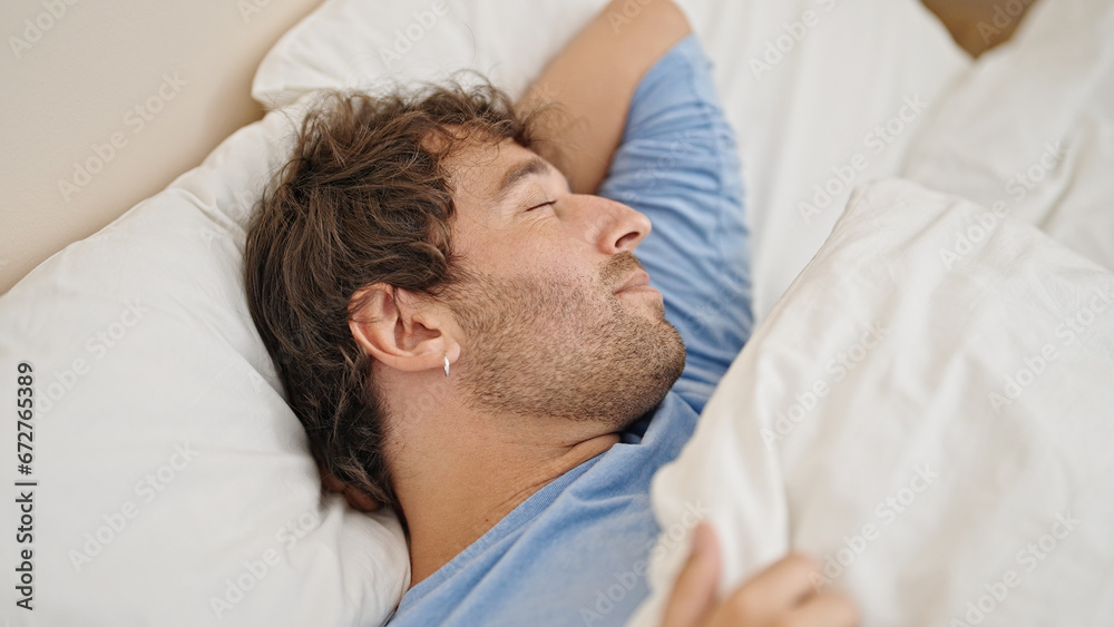 Young hispanic man lying on bed sleeping at bedroom Young hispanic man lying on bed sleeping at bedroom