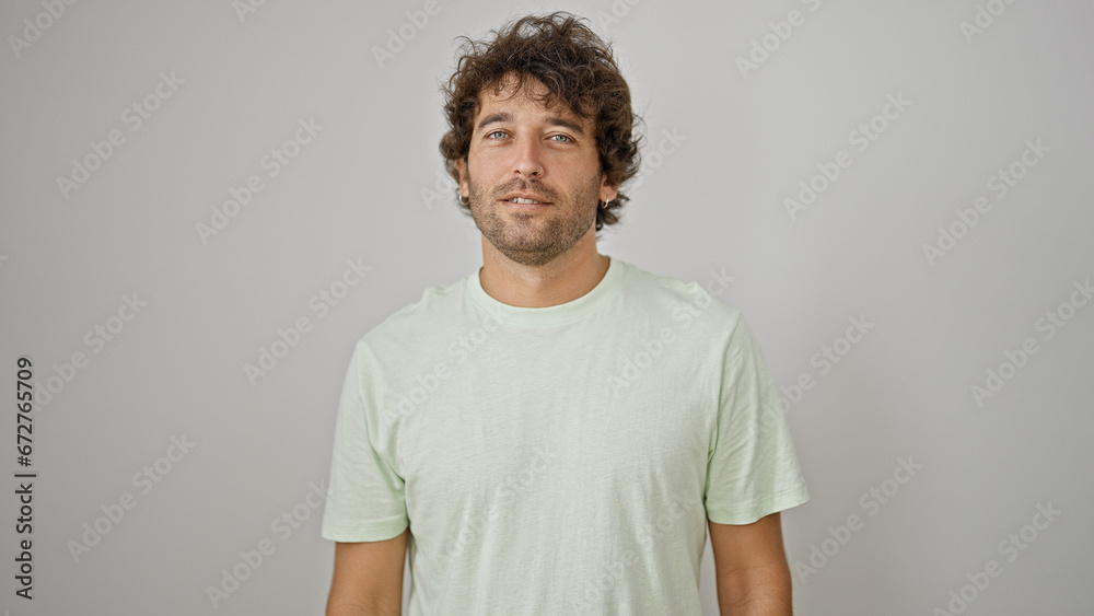 Young hispanic man standing with serious face over isolated white background Young hispanic man standing with serious face over isolated white background