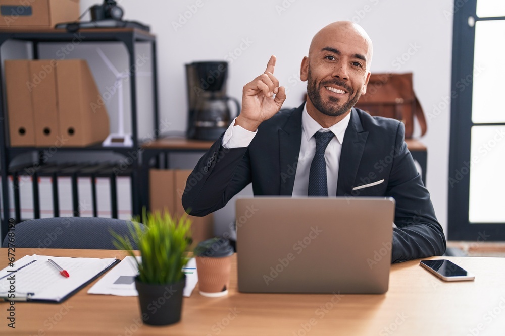 Middle age bald man working at the office surprised with an idea or question pointing finger with happy face, number one Middle age bald man working at the office surprised with an idea or question pointing finger with happy face, number one