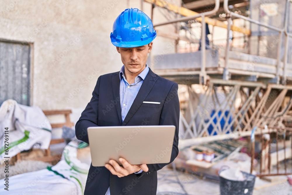 Young man architect using laptop at street Young man architect using laptop at street