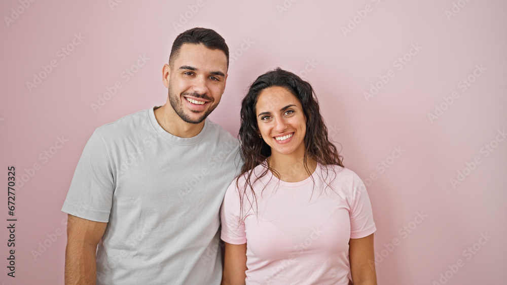 Man and woman couple smiling confident standing together over isolated pink background Man and woman couple smiling confident standing together over isolated pink background