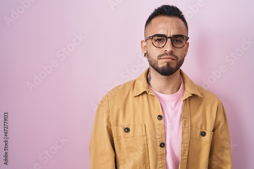 Young hispanic man standing over pink background skeptic and nervous, frowning upset because of problem. negative person. © Krakenimages.com