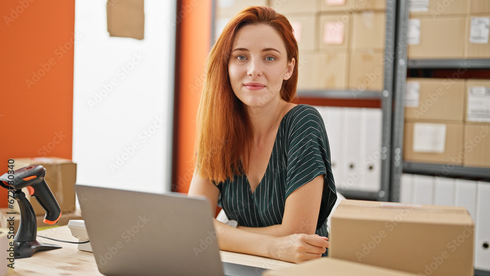 Young redhead woman ecommerce business worker using laptop smiling at office Young redhead woman ecommerce business worker using laptop smiling at office