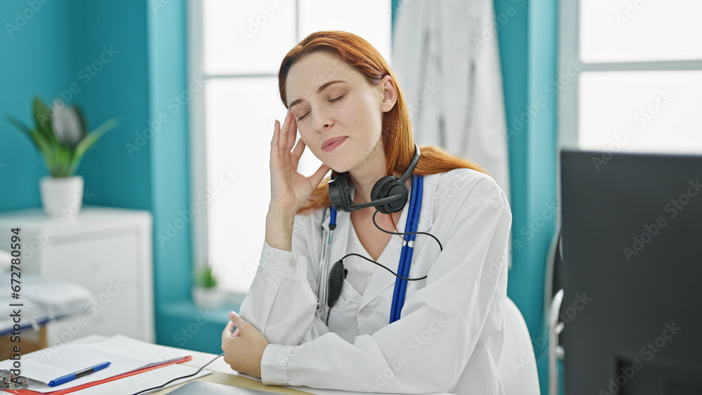 Young redhead woman doctor stressed working at clinic Young redhead woman doctor stressed working at clinic